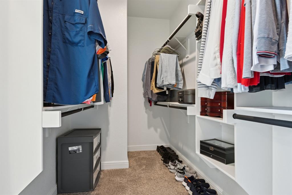 1504 Rachel Street Northlake, TX 76247 - Photo 34 of 40 a view of walk in closet with clothes and shoes