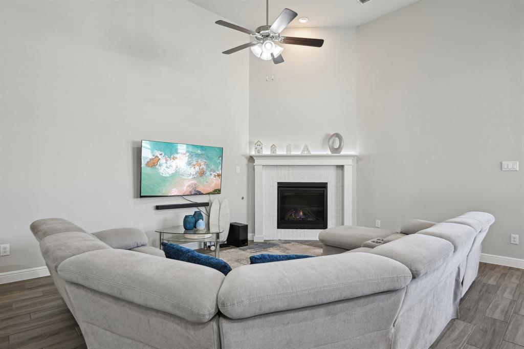 1504 Rachel Street Northlake, TX 76247 - Photo 6 of 40 a living room with furniture a fireplace and a flat screen tv