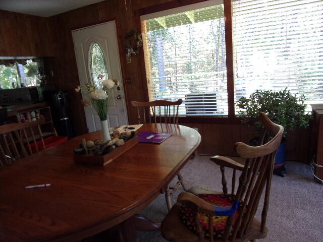 16880 Ford Road Rogue River, OR 97537 - Photo 8 of 37 dining area open to sunroom, large living room and cozy fireplace