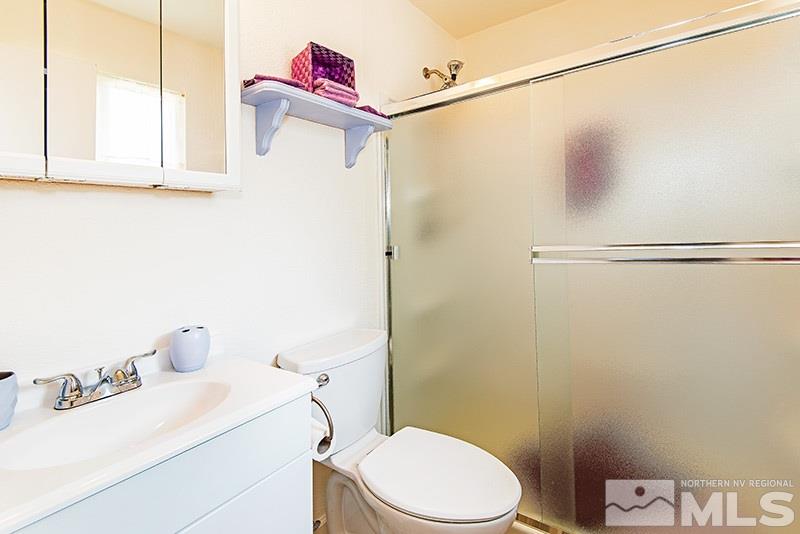 3480 Pierremont Road Reno, NV 89503 - Photo 12 of 16 a white toilet sitting next to a bathroom sink