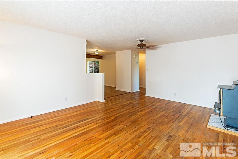 3480 Pierremont Road Reno, NV 89503 - Photo 4 of 16 a view of empty room with wooden floor