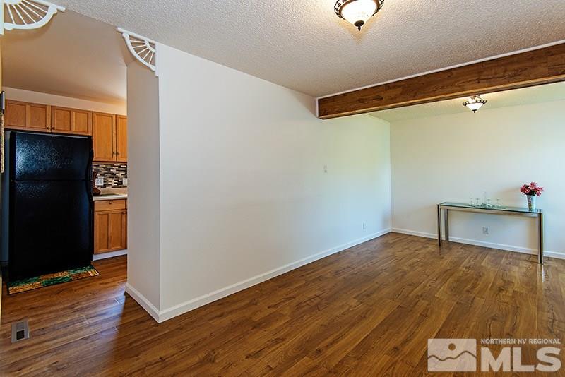 3480 Pierremont Road Reno, NV 89503 - Photo 5 of 16 a view of an empty room with wooden floor and a window