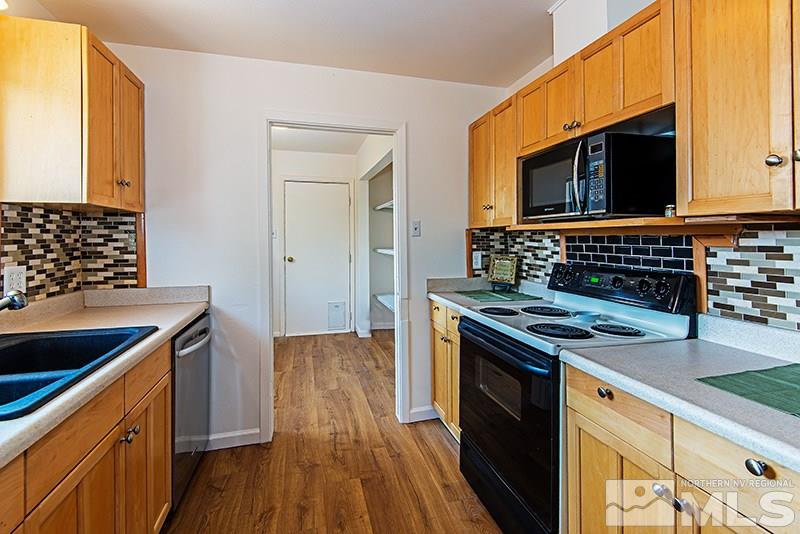 3480 Pierremont Road Reno, NV 89503 - Photo 8 of 16 a kitchen with stainless steel appliances granite countertop a stove and a microwave