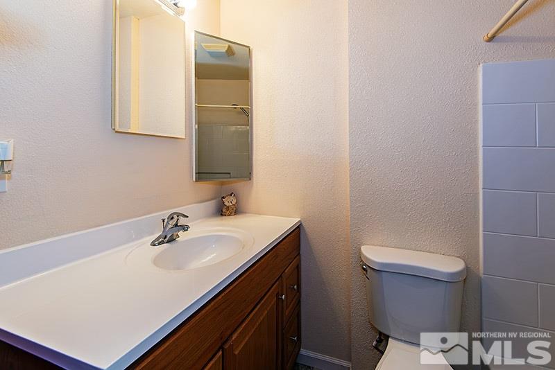 3480 Pierremont Road Reno, NV 89503 - Photo 10 of 16 a bathroom with a sink a toilet and mirror