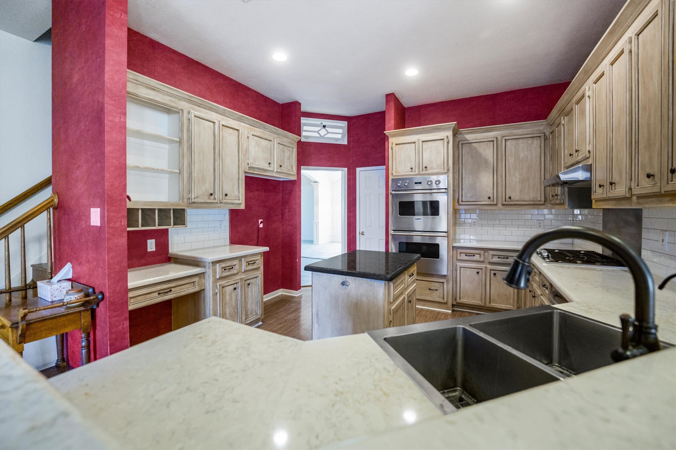 2434 Pebblebrook Circle Conroe, TX 77384 - Photo 13 of 44 a kitchen with stainless steel appliances kitchen island a sink stove and a refrigerator