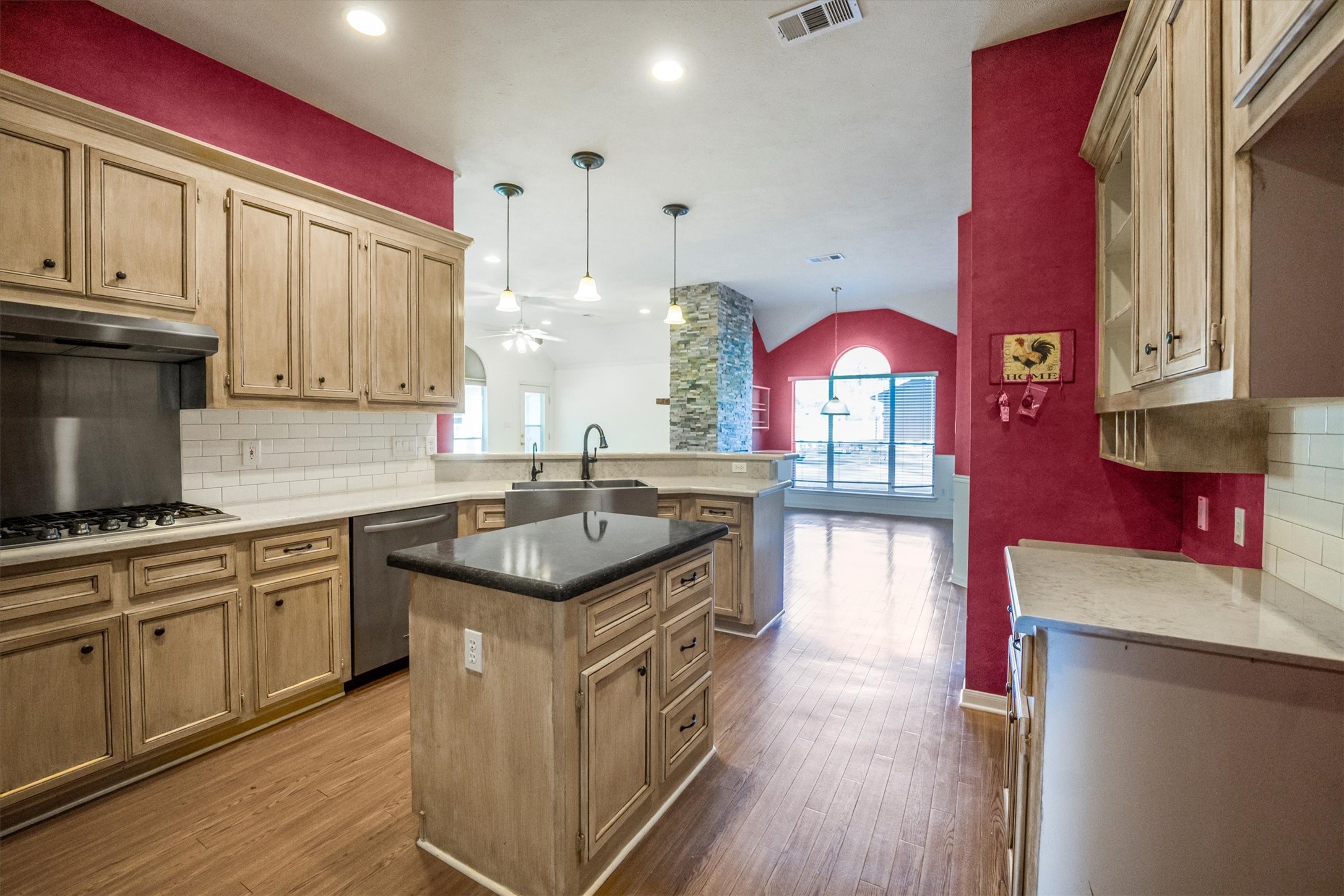 2434 Pebblebrook Circle Conroe, TX 77384 - Photo 14 of 44 a kitchen with stainless steel appliances granite countertop a stove a sink and a wooden floors