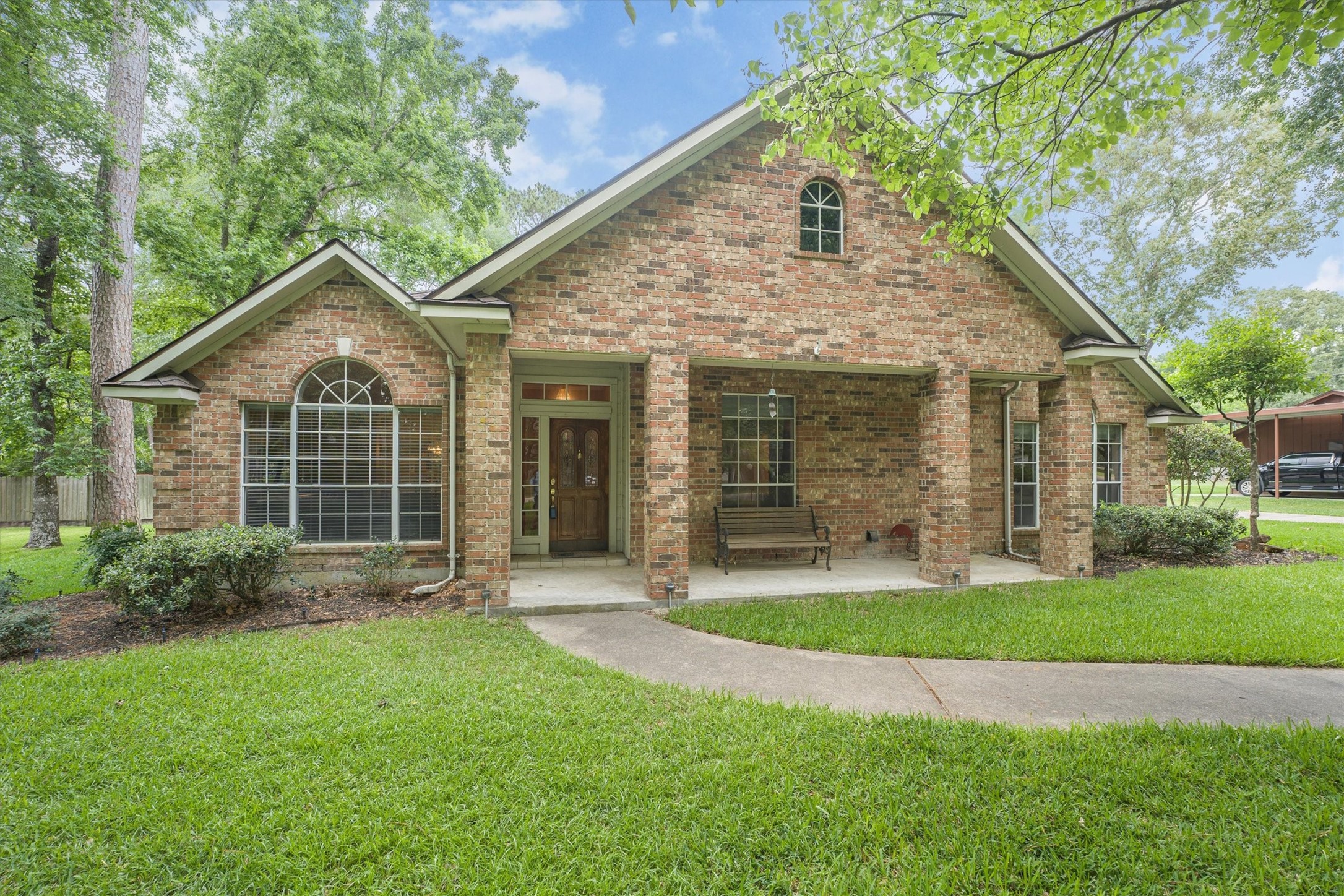2434 Pebblebrook Circle Conroe, TX 77384 - Photo 33 of 44 a front view of a house with a yard and garage