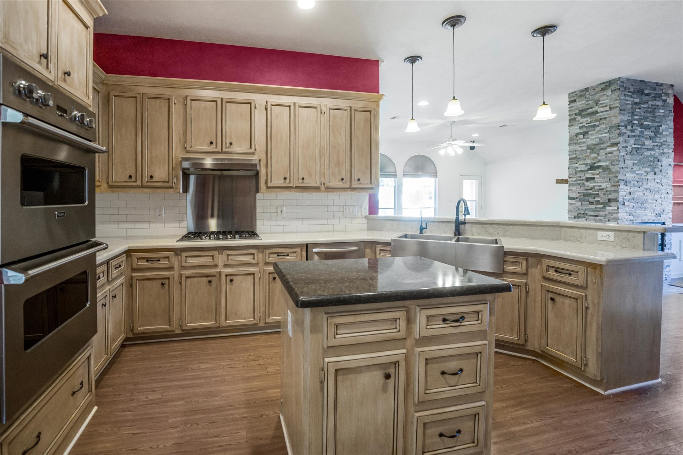 2434 Pebblebrook Circle Conroe, TX 77384 - Photo 4 of 44 a kitchen with stainless steel appliances granite countertop a sink a stove and a wooden cabinets