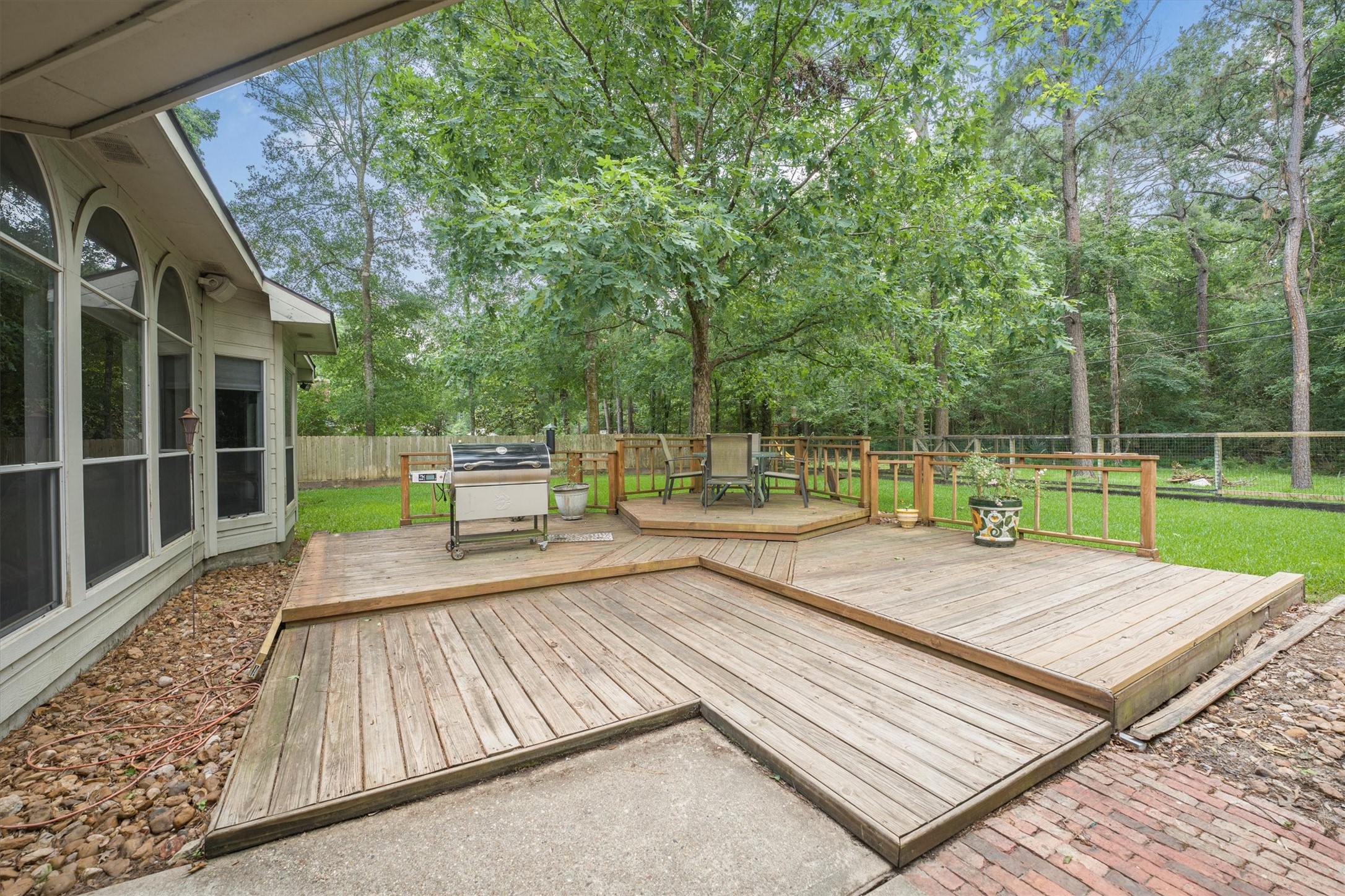 2434 Pebblebrook Circle Conroe, TX 77384 - Photo 42 of 44 a view of a wooden deck with a yard
