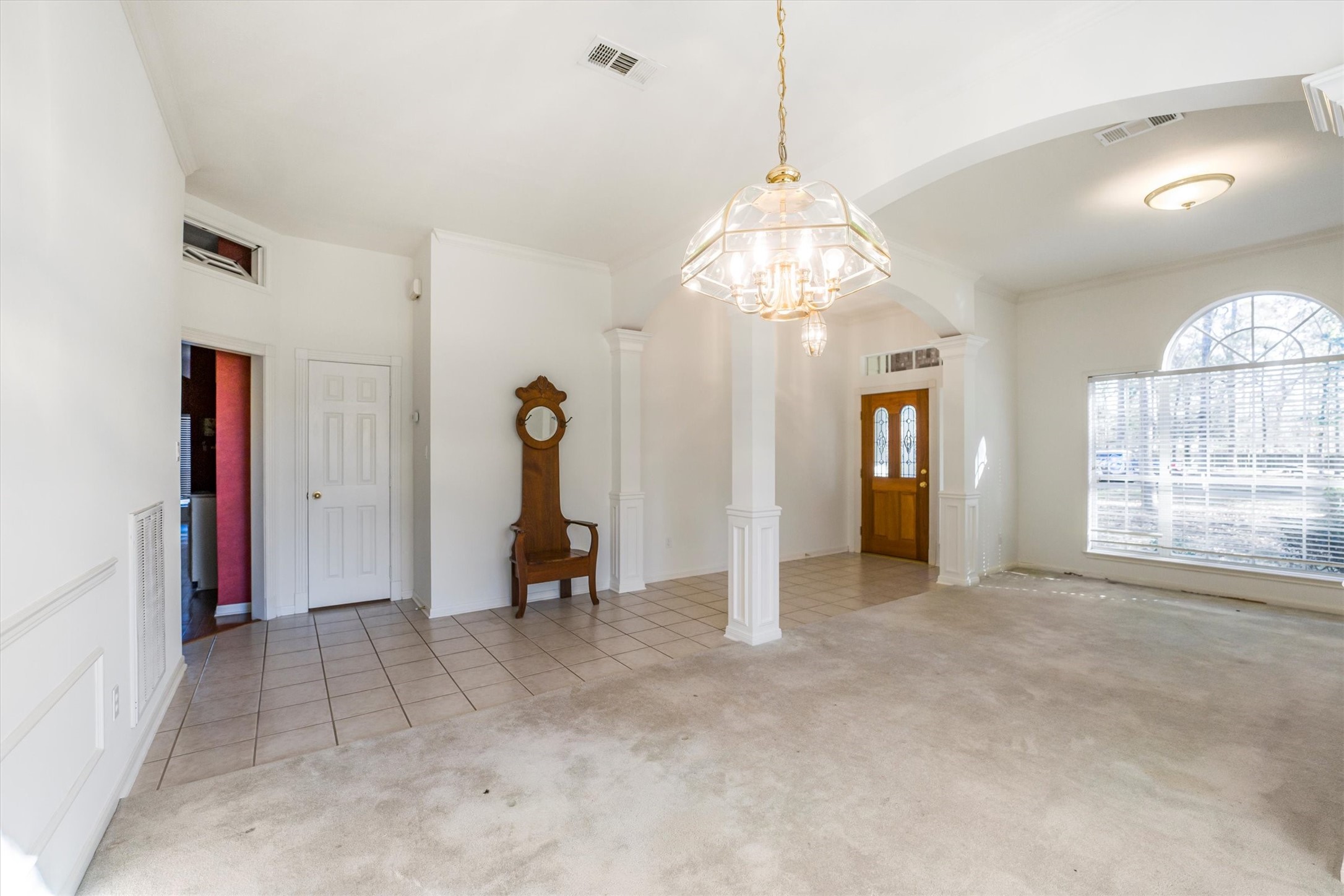2434 Pebblebrook Circle Conroe, TX 77384 - Photo 8 of 44 a view of a livingroom with a chandelier fan and windows