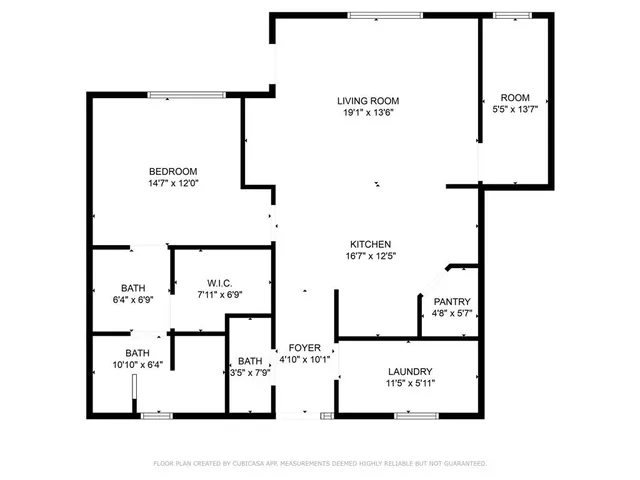 a view of an empty room with kitchen appliances and a ceiling fan