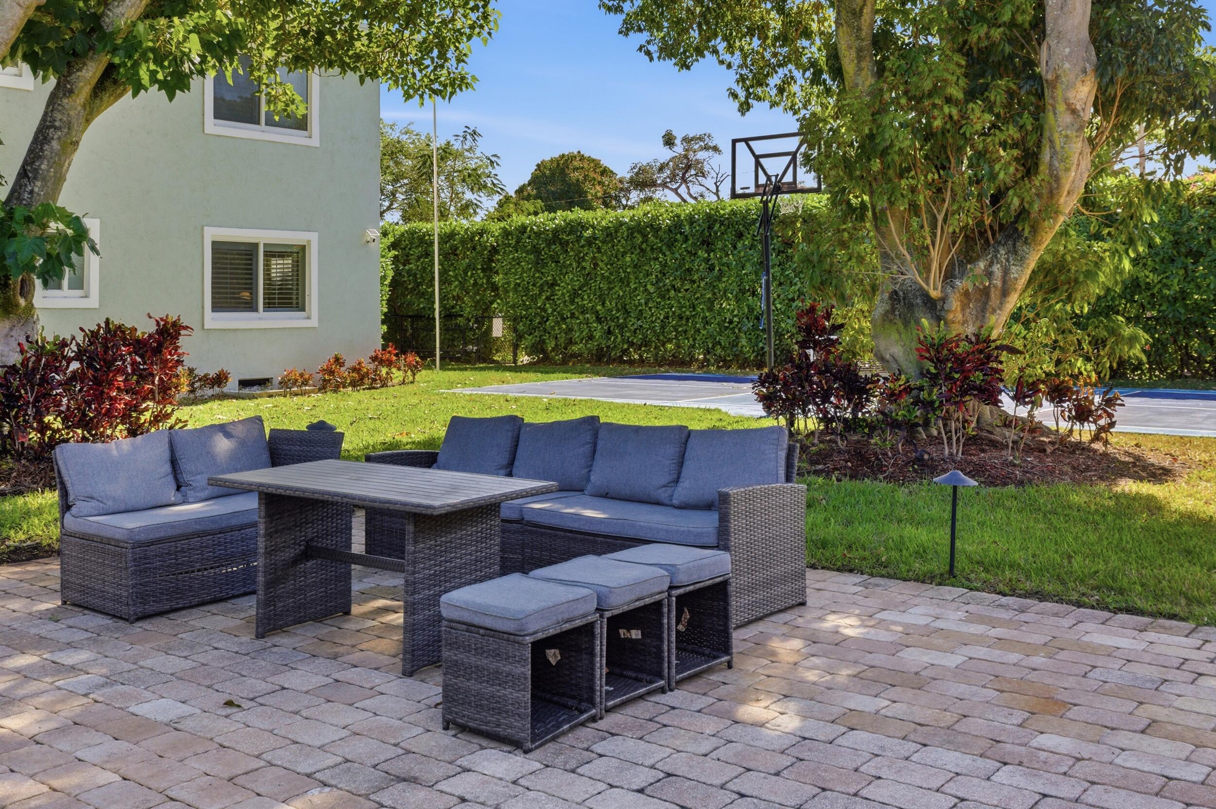 921 Ortega Road West Palm Beach, FL 33405 - Photo 50 of 60 a view of a chairs and table in the back yard of the house
