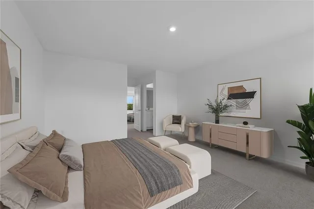 a bedroom with bed chair and mirror