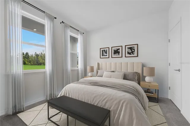 a bedroom with a large bed and a window