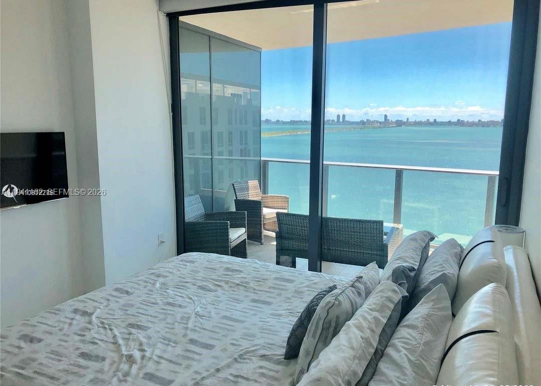 460 Northeast 28th Street, Unit 1907 Miami, FL 33137 - Photo 3 of 7 a bedroom with a bed and a television