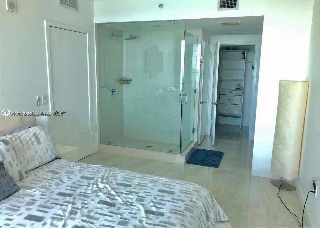 460 Northeast 28th Street, Unit 1907 Miami, FL 33137 - Photo 4 of 7 a bedroom with a bed and a shower