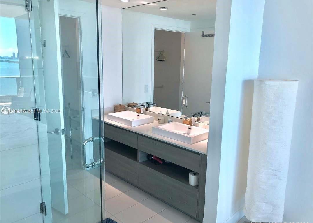 460 Northeast 28th Street, Unit 1907 Miami, FL 33137 - Photo 5 of 7 a bathroom with a sink and a mirror