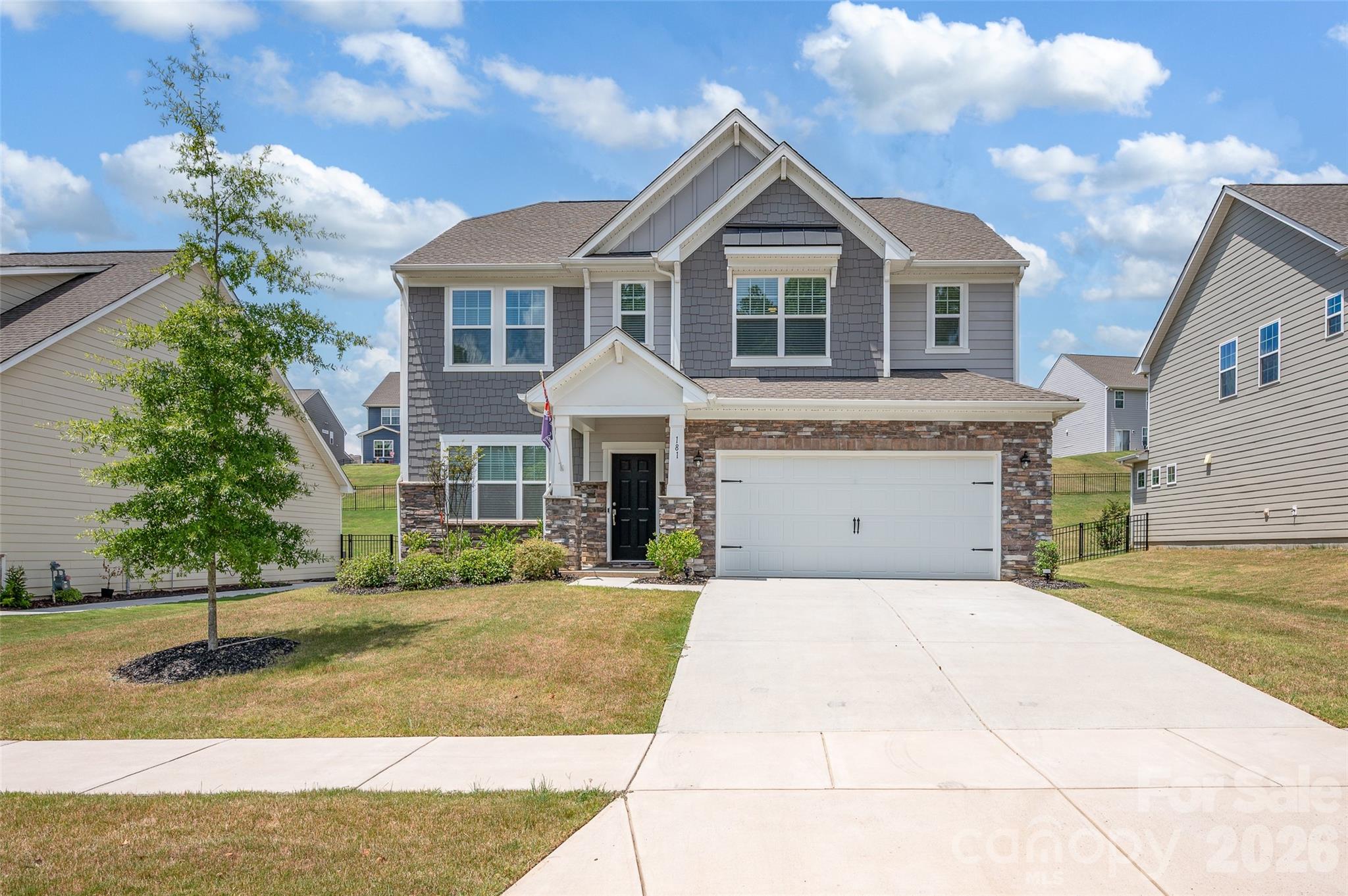 a front view of a house with a yard and garage