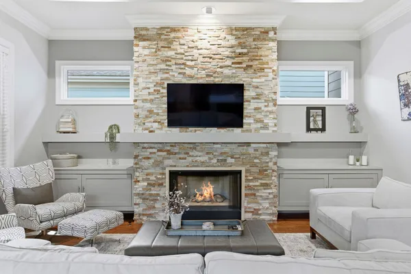 a kitchen with stainless steel appliances granite countertop a refrigerator a sink dishwasher a stove and white cabinets with wooden floor