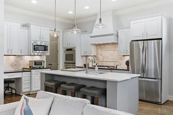 a kitchen with a stove a sink and a refrigerator