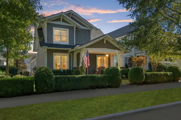 a front view of a house with a garden