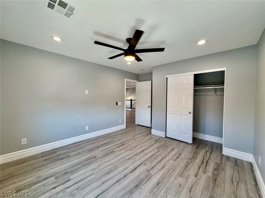 135 Tall Ruff Drive Las Vegas, NV 89148 - Photo 25 of 29 A spacious bedroom features modern flooring and a practical sliding closet.