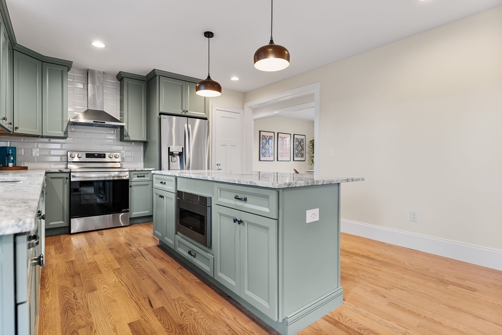 37 Lantern Lane Braintree, MA 02184 - Photo 12 of 40 a kitchen with stainless steel appliances granite countertop a stove a sink and a refrigerator