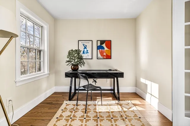 a view of a workspace with furniture and a window