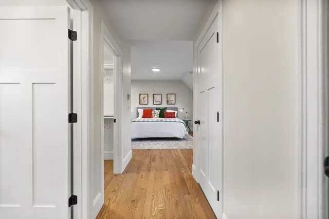 a view of a hallway with wooden floor and closet
