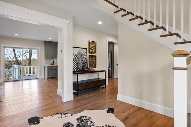 a view of entryway and hall with wooden floor