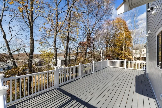 a view of a balcony with wooden floor and fence