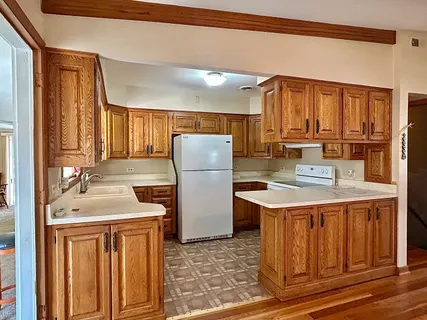 a kitchen with kitchen island granite countertop a stove and a refrigerator