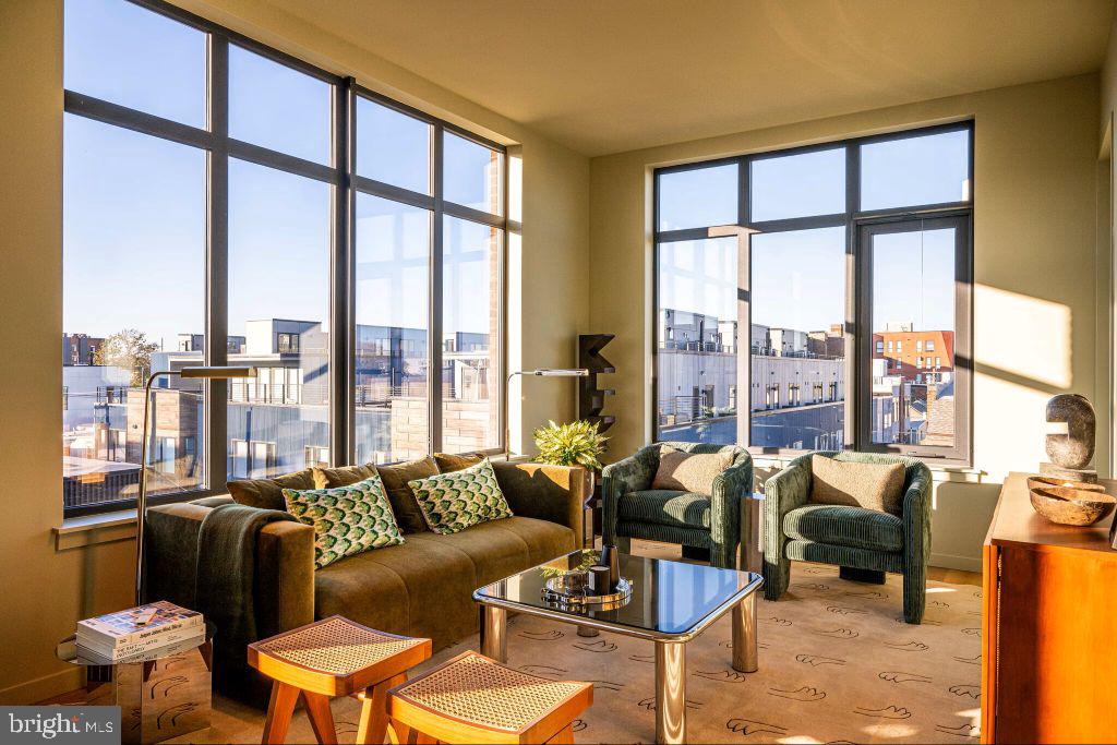 1700 North Front Street, Unit 1B218 Philadelphia, PA 19122 - Photo 5 of 22 a living room with furniture and floor to ceiling windows
