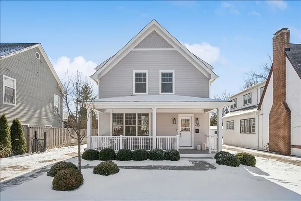 a front view of a house with yard and parking