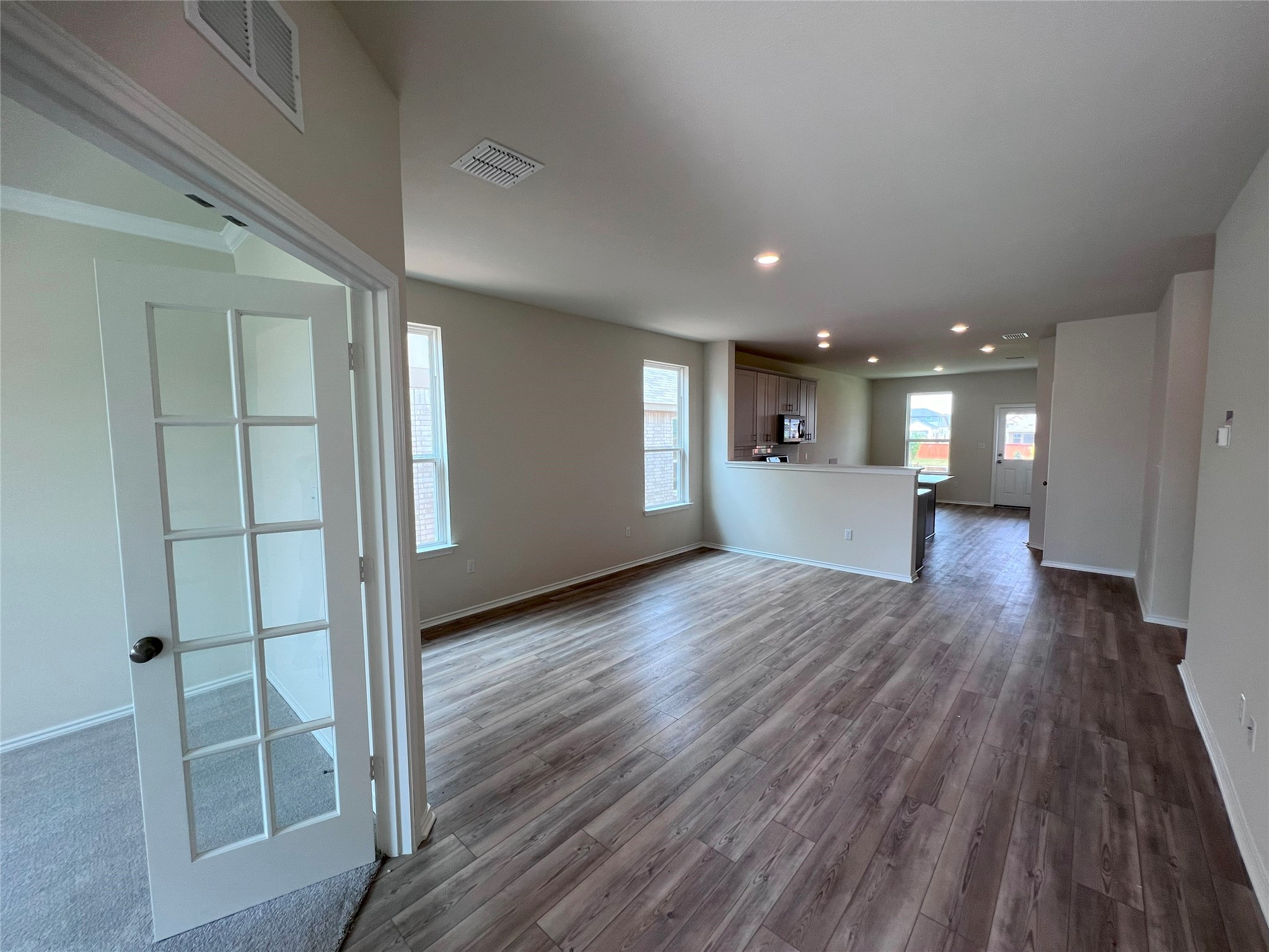 427 Tree Nut Loop Buda, TX 78610 - Photo 5 of 38 a view of empty room with wooden floor
