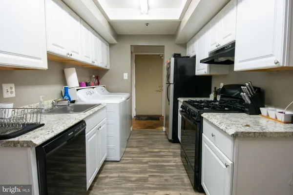 a stove top oven sitting inside of a kitchen