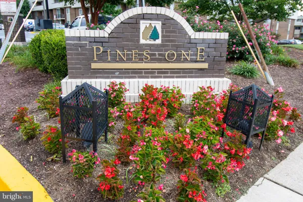 a sign that is in front of flowers