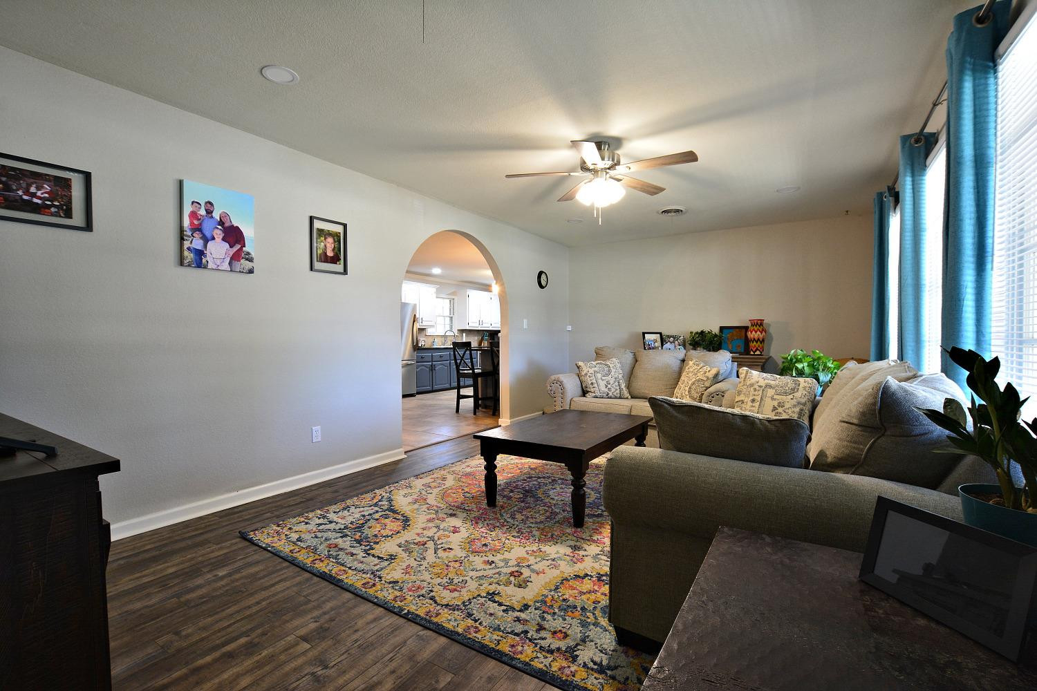 4903 17th Street Lubbock, TX 79416 - Photo 6 of 25 a living room with furniture and a chandelier