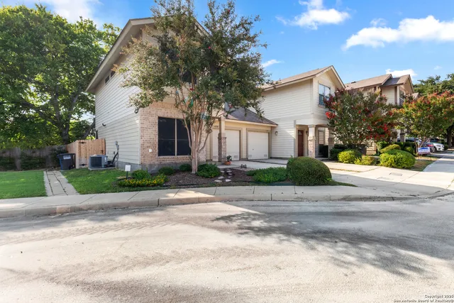 a front view of a house with a yard and a garage