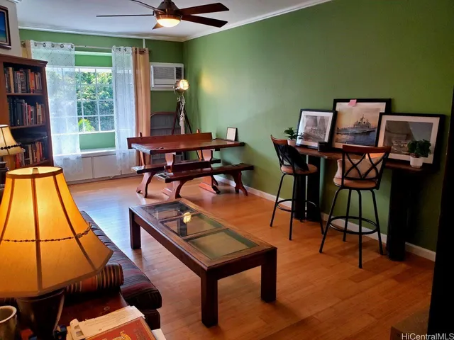 a living room with furniture a window and a flat screen tv