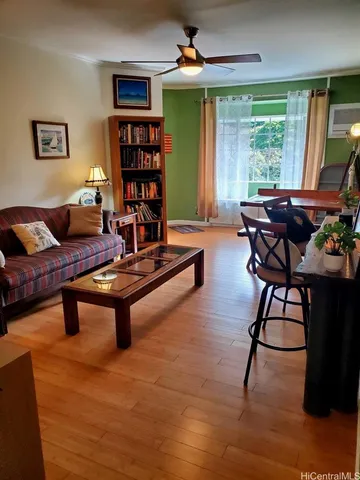 a living room with furniture a window and a bookshelf