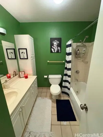 a white toilet sitting next to a bathroom sink and tub