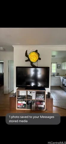 a view of living room with stainless steel appliances and kitchen view