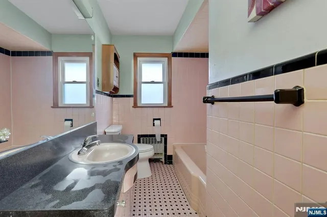 a bathroom with a sink a mirror and a shower