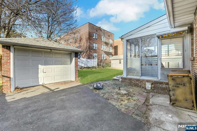 a view of a house with a yard and garage