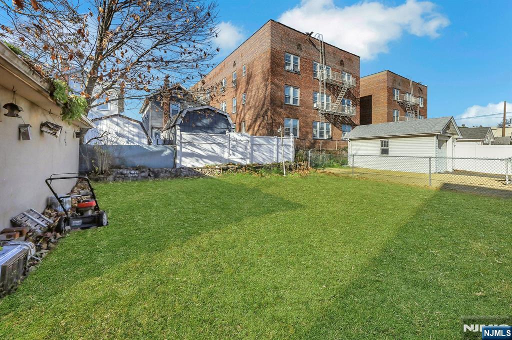 835 Chestnut Street Kearny, NJ 07032 - Photo 19 of 26 a view of a building next to a big yard