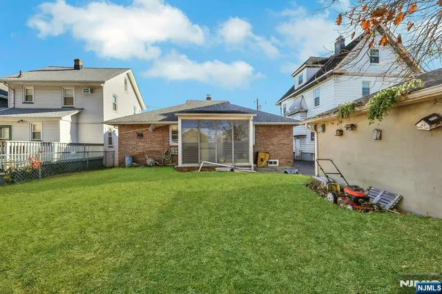 a view of a house with a backyard