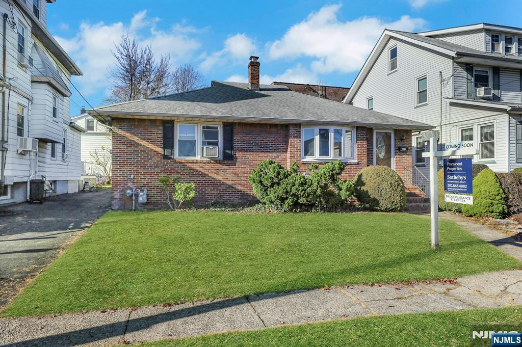 835 Chestnut Street Kearny, NJ 07032 - Photo 23 of 26 a front view of a house with a garden
