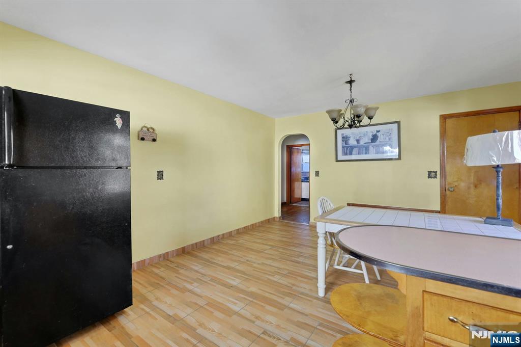 835 Chestnut Street Kearny, NJ 07032 - Photo 7 of 26 a kitchen with a table and refrigerator