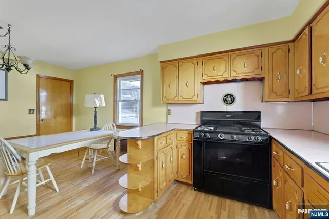 a kitchen with a stove and a wooden floors
